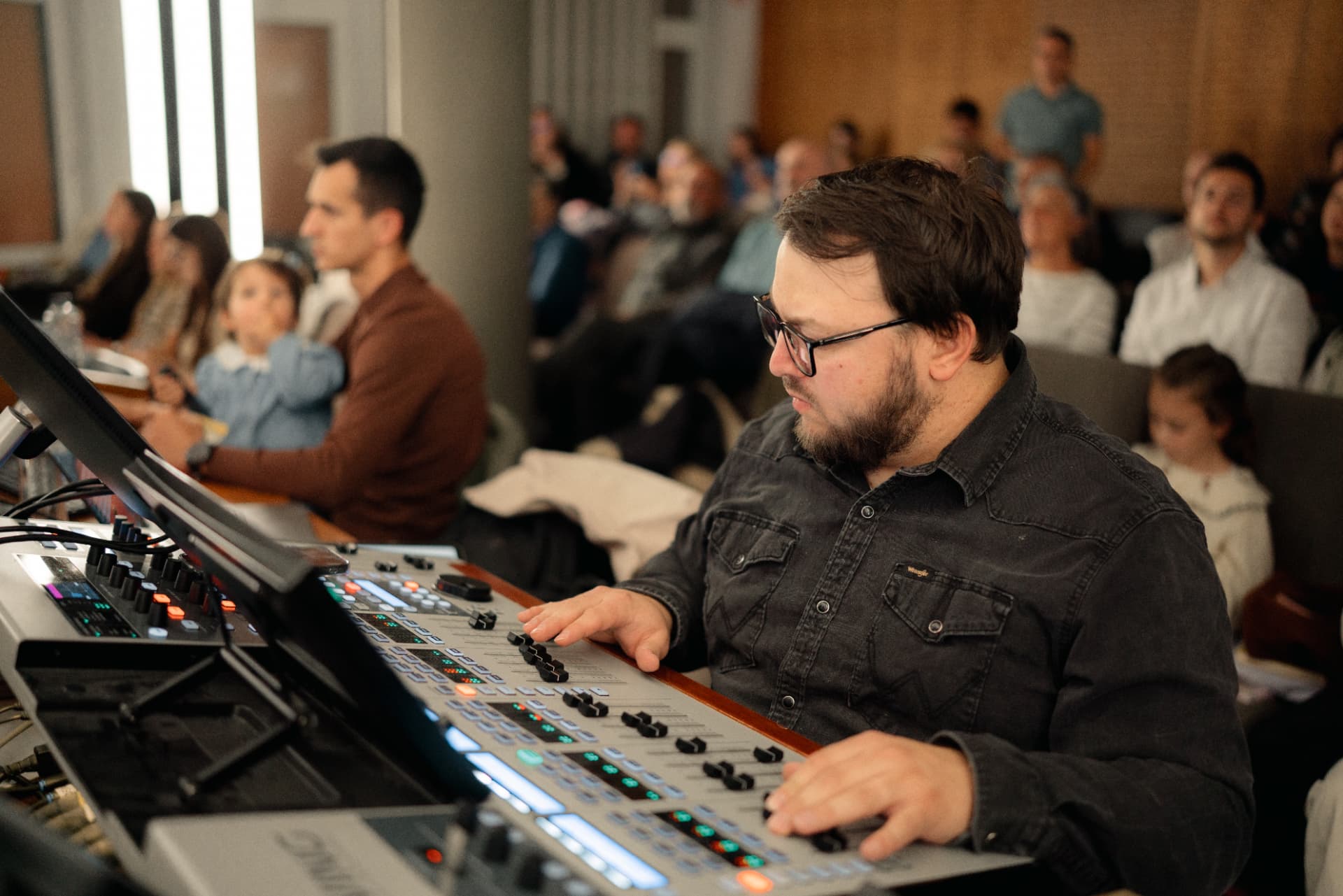 Emanuel Daniciuc mixing a live event on a Behringer digital console